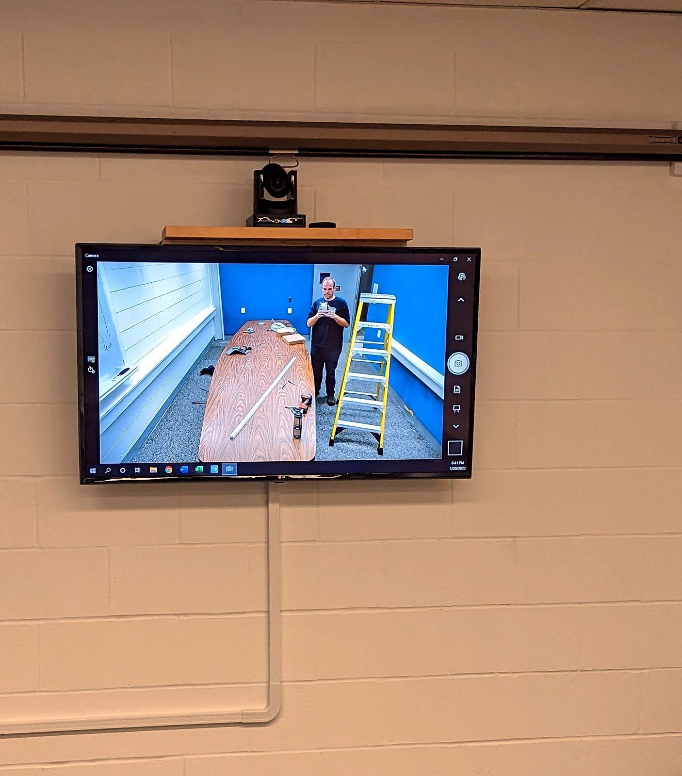 Conference room PTZ camera and display